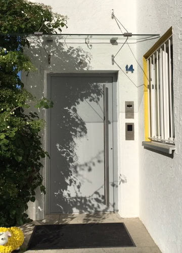 Hauseingangstür mit moderner Sicherheitstechnik und Hausnummer 14.